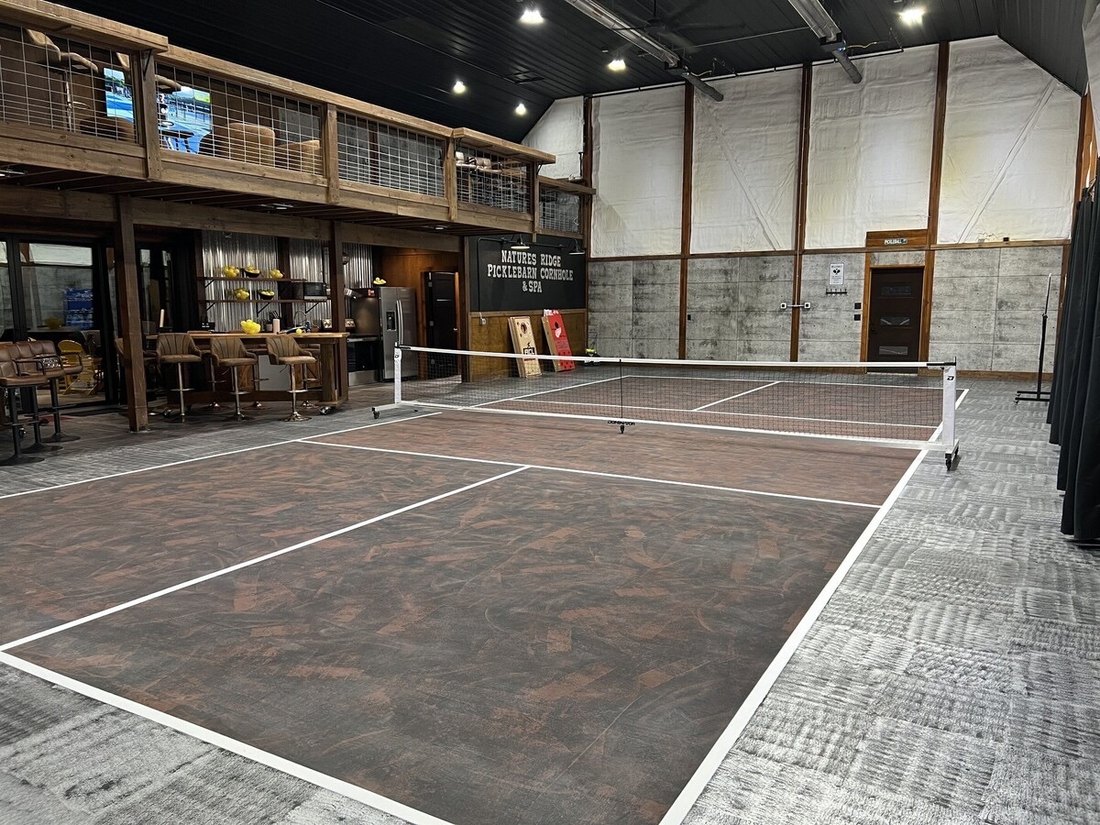 Indoor pickleball court with lounge